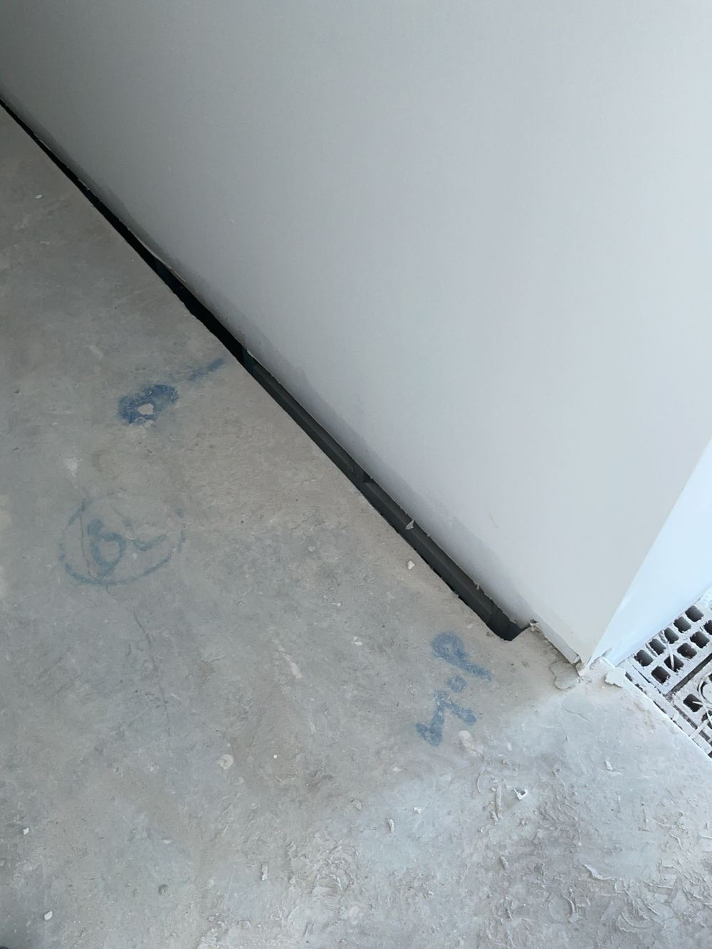 Concrete slab stopping short of the garage wall, found during a fixing stage inspection in Cobbitty