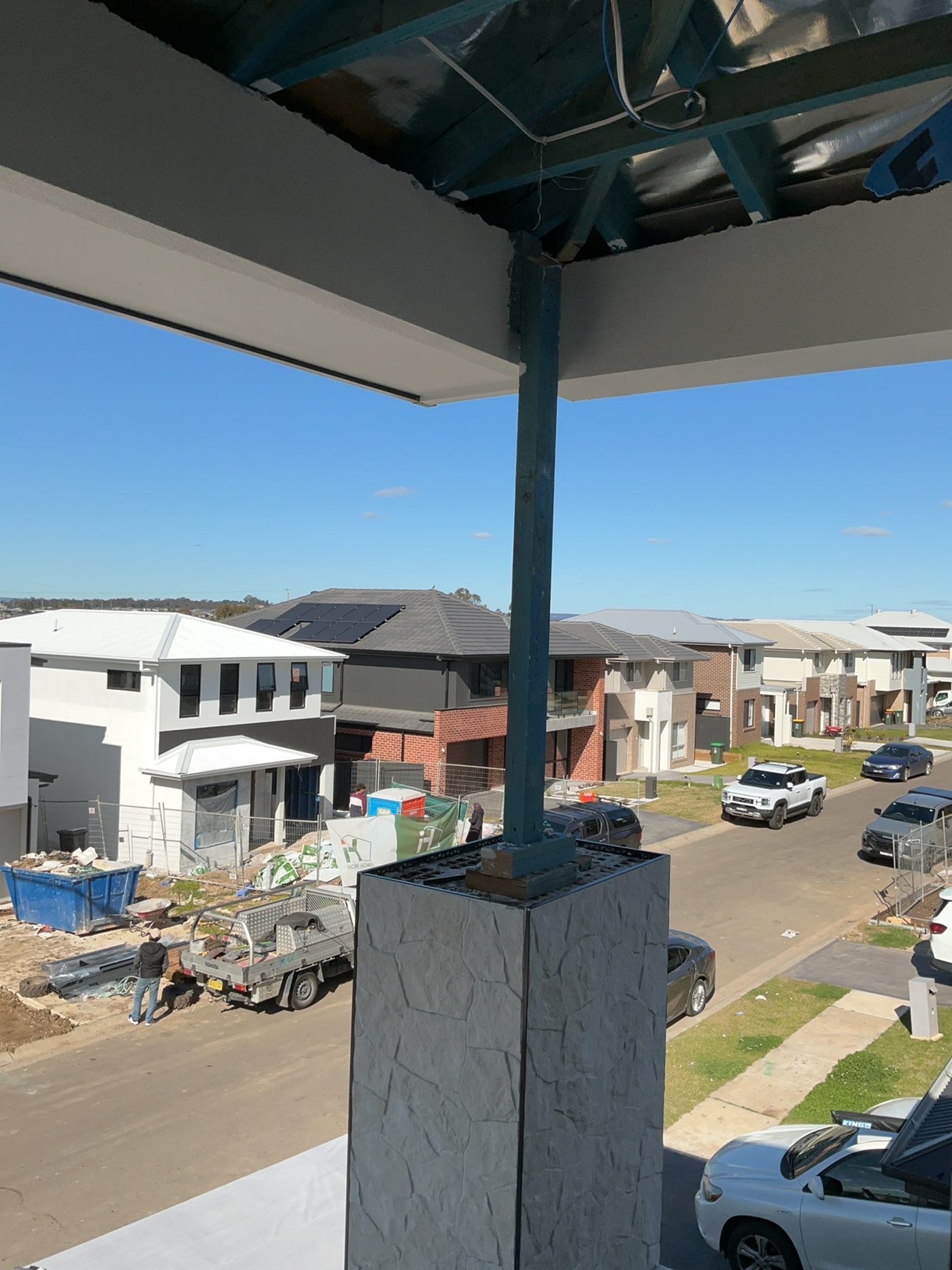 Balcony roof supported by a temporary post with inadequate support, found during a lock-up inspection in Cobbitty
