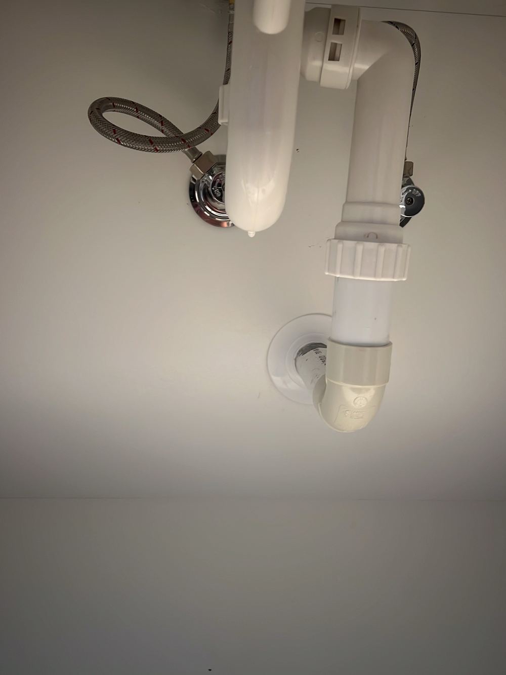 Mixer pipe leaking under the vanity at handover, found during a handover inspection in Cobbitty