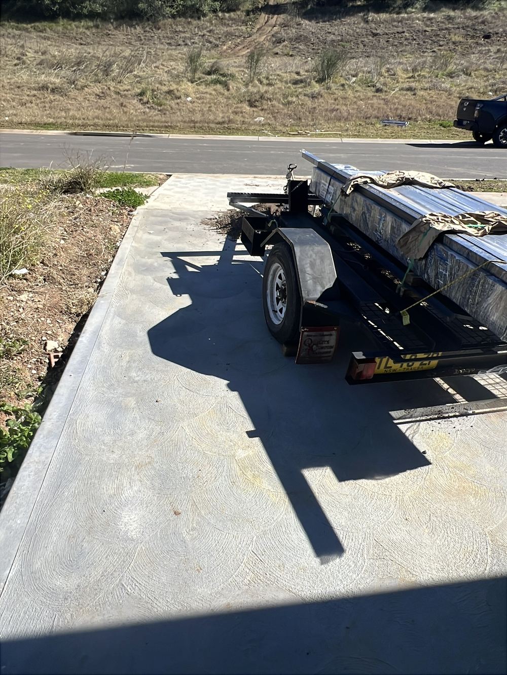 Driveway control joints never saw cut after the pour, found during a handover inspection in Cobbitty
