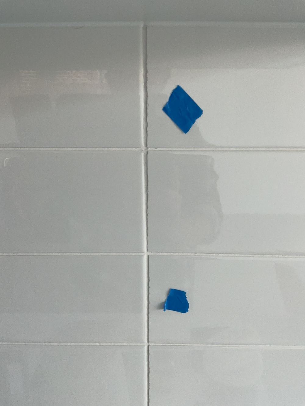 Splashback tiling finished with poor workmanship, Cobbitty